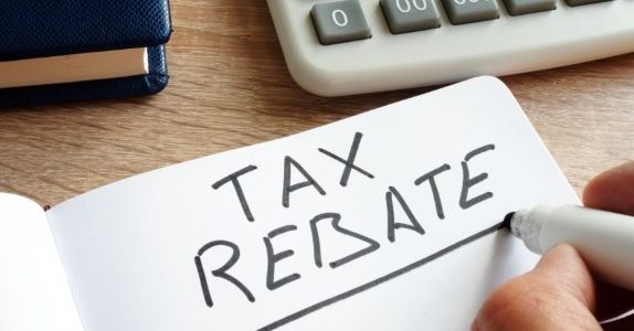High efficient furnace installation tax credit person writing tax rebate on paper