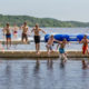 boy scouts jumping into lake