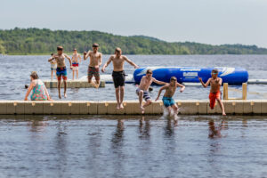 boy scouts jumping into lake